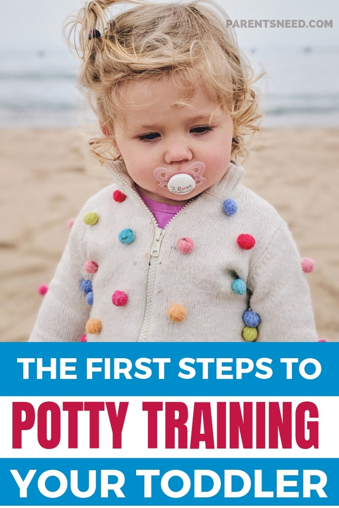 Toddler with pacifier on beach