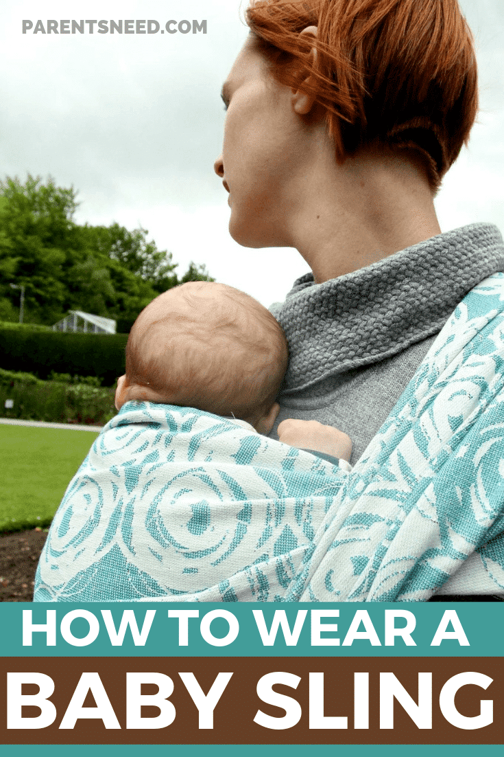 Woman carrying her child in a baby sling.