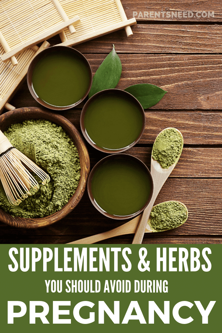 Various herbs in bowls on wooden table.