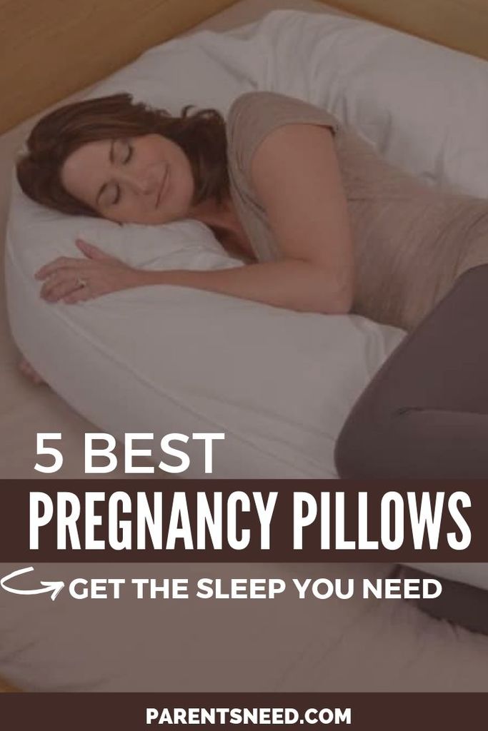 A pregnant woman using a pregnancy pillow