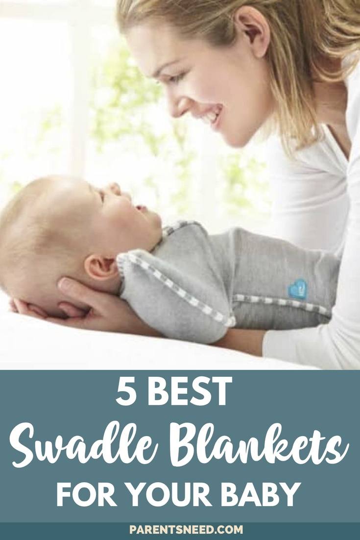 a mother placing her baby down to swaddle