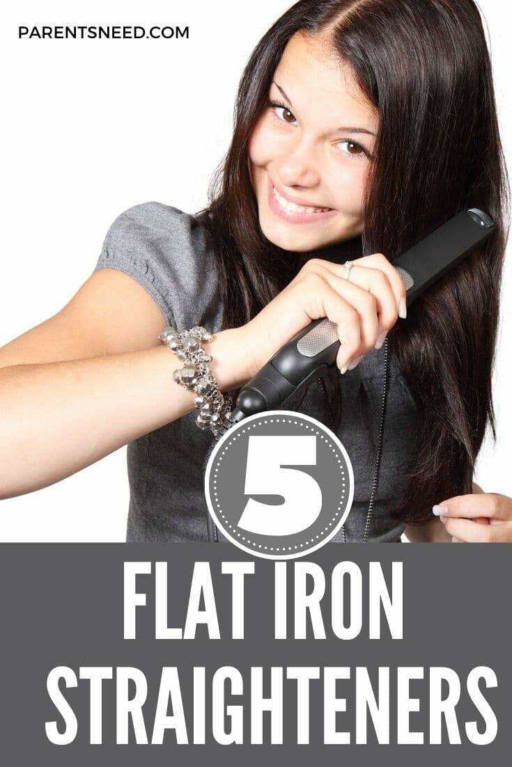 woman using flat iron to straighten her hair